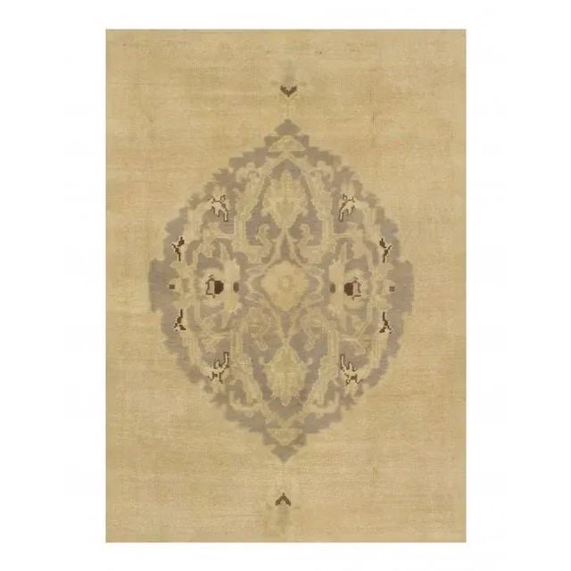 This Turkish rug epitomizes the provincial style of Oushak weaving, which is beloved among collectors and decorators...