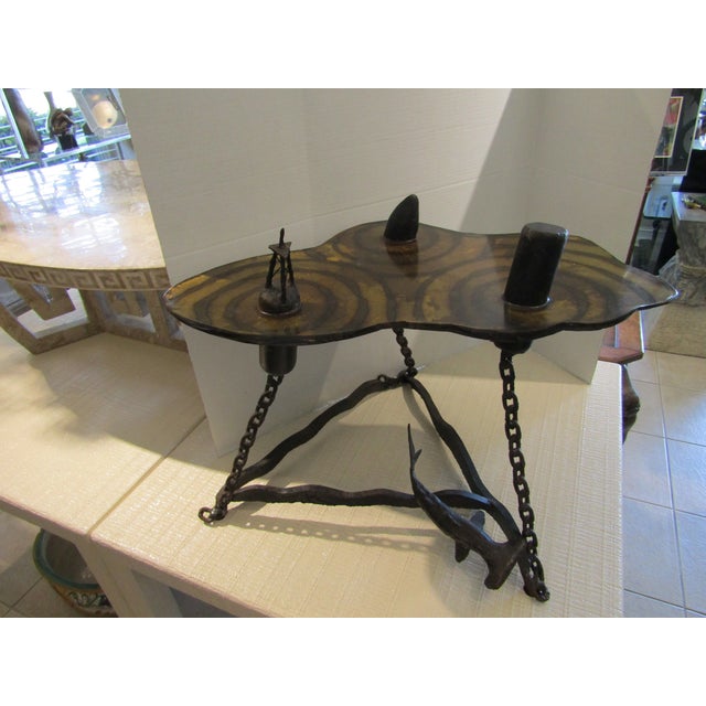 This on-of-a-kind hand made table has a nautical motif. The top is made of steel, etched and torched to resemble water. It...