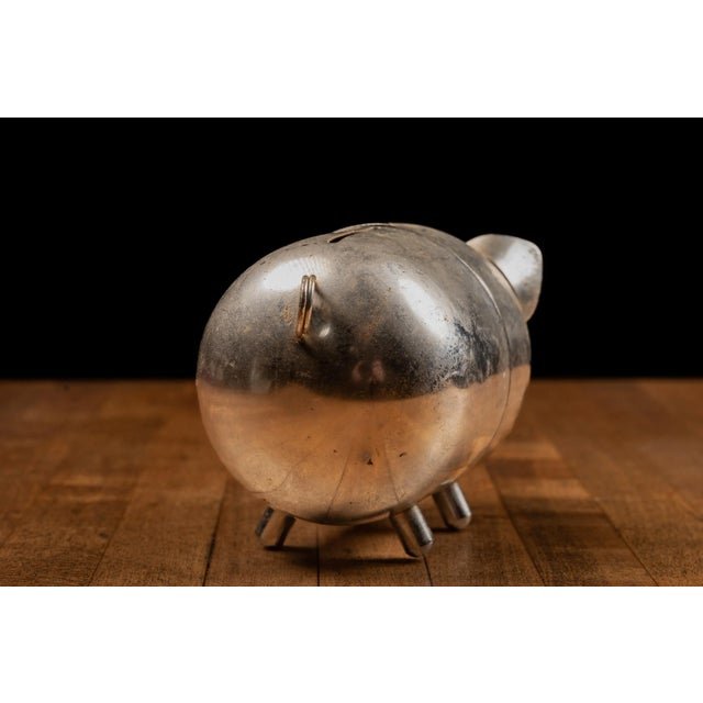 Vintage cast metal piggy bank. 4"L x 3"H. This vintage piggy bank originated in Hong Kong. JM - 031723 - 105999