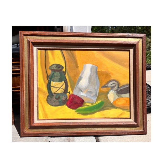Framed in a gilt wood and linen lined frame this is an original mid-century still life oil painting depicting a lantern,...