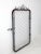 A galvanized steel chain link gate from the mid-20th century with rounded corners and an arched top formed by looping...