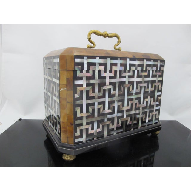 Maitland Smith mother of pearl inlaid caddy box featuring a stunning geometric tessellated design. Four brass feet and...
