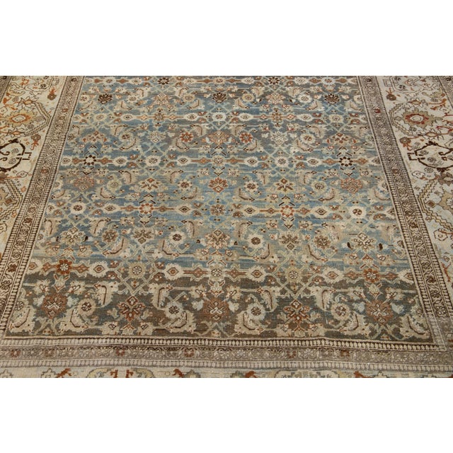 Beautiful antique Bidjar hand-knotted wool rug with a blue color field. This Persian rug has rust and brown accents in a...