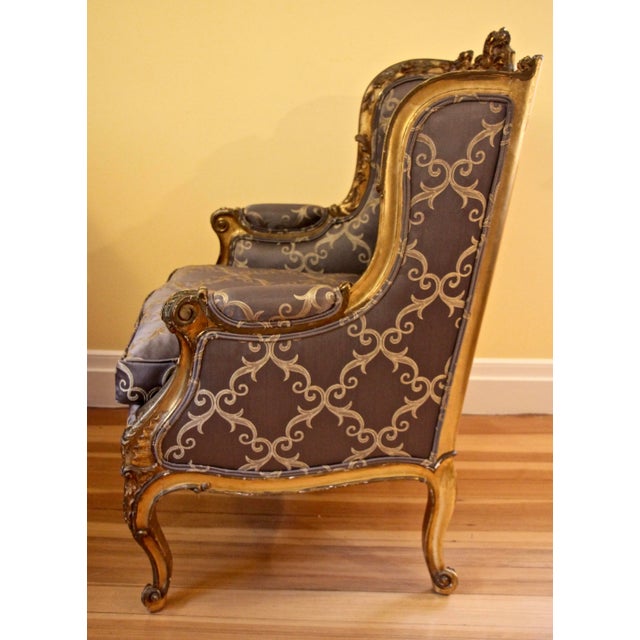 19th century gilded wood bergère, France. Unique bergère, frame made of carved and gilded wood, with exquisite flower and...