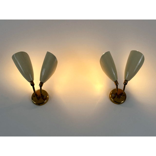 Set of two extremely rare and lovely mid-century modern sconces or wall lamps with adjustable lamp shades. Designed and...