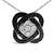 Embrace the elegance of the unexpected with this sterling silver necklace, adorned with a geometric knot pendant that...
