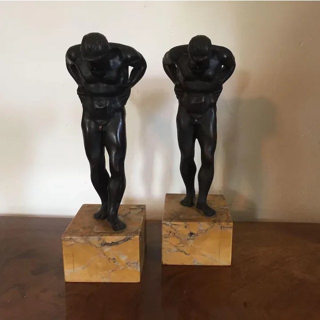 Pair 19th c. Grand Tour bronze figures of Atlas. The athletes are depicted in contrapposto with head bowed and hands...