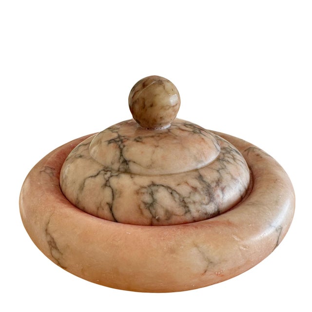A low round urn shape, pale pink alabaster box with gray veining. Very heavy and an attractive design. Signed on bottom....