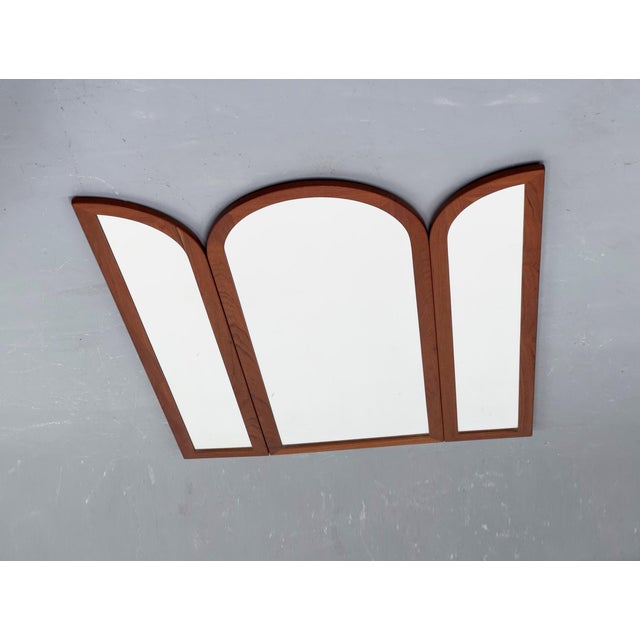 Folding, high-quality wall mirror with a solid teak frame, made in Denmark. Mounts to the wall with metal brackets on the...