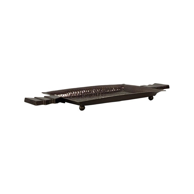 Featuring a rectangular hammered metal surface and distinctive stepped triangle handles, this tray brings texture, shine,...