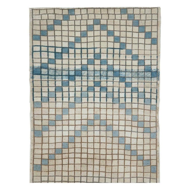 A vintage Turkish Anatolian modernist small rug in runner format handmade during the mid-20th century in shades of cream,...