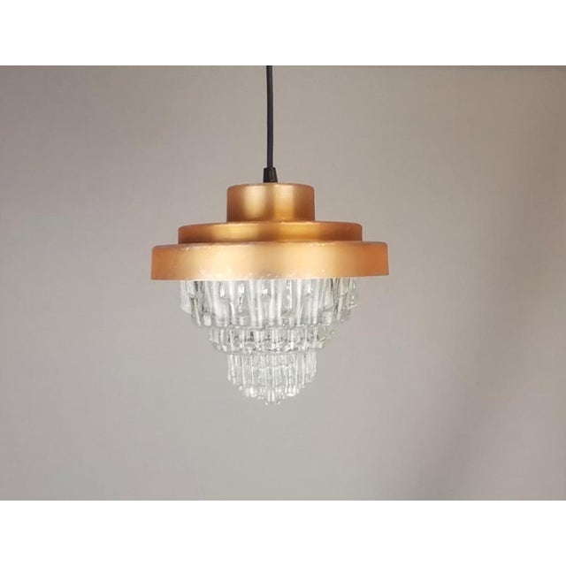 Mid-Century Modern Clear Glass and Metallic Copper Colored Aluminum Hanging Lamp, 1960s, in Very Good conditions. Designed...