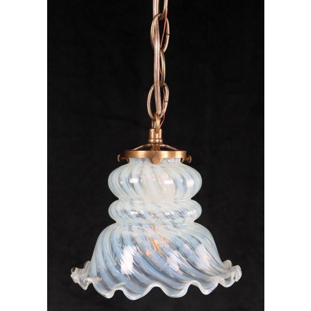 Art Nouveau glass shade hanging light, with a counterclockwise opal glass swirl and a scalloped edge. This requires one...