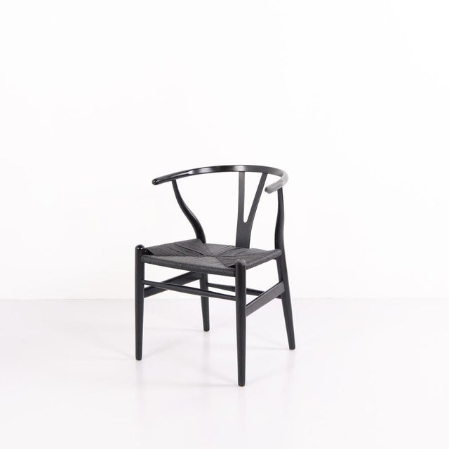 Ch24 wishbone chair designed by hans j. Wegner and manufactured by carl hansen & søn. Crafted in black-painted wood with a...