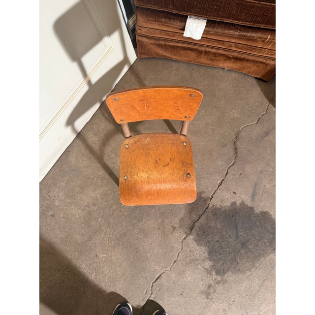 This Irwin kindergarten, child-sized school chair features a wooden backrest and seat with a steel frame. Assembled in the...