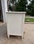 Wide dresser featuring 6 drawers with raised molding detail, turned feet and rosette carvings at each corner. Painted in a...
