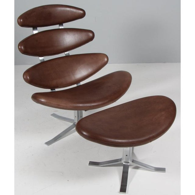 Poul M. Volther lounge chair and ottoman in original patinated full grain leather. Frame of brushed steel. Model EJ-5...