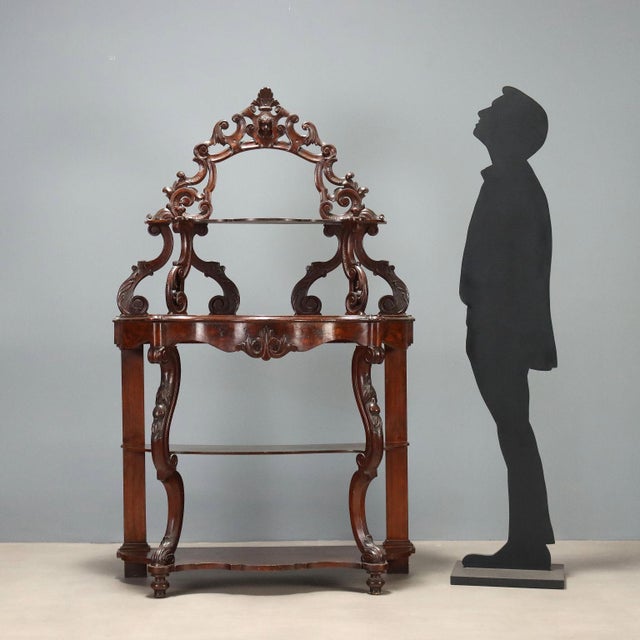 The Luigi Filippo walnut étagère is distinguished by the elegance of its molded top, supported by shaped legs with refined...