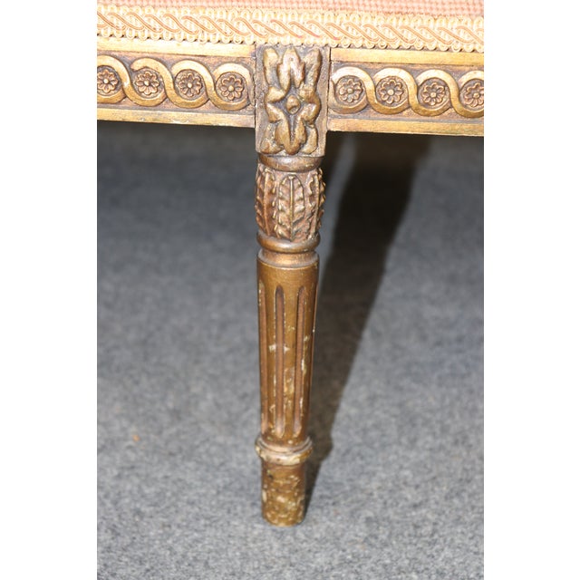 This elegant French Louis XVI giltwood bench showcases the refined craftsmanship and timeless beauty of neoclassical...