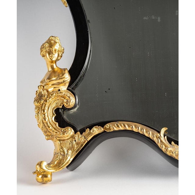 Louis xv style mirror, may be used as table mirror or wall mirror, made in gilt bronze, blackened wood. 1860-1880s...