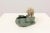 Art Deco style and period ashtray, made of soft ceramic paste. It represents a polar bear on a bluish-green cave that...