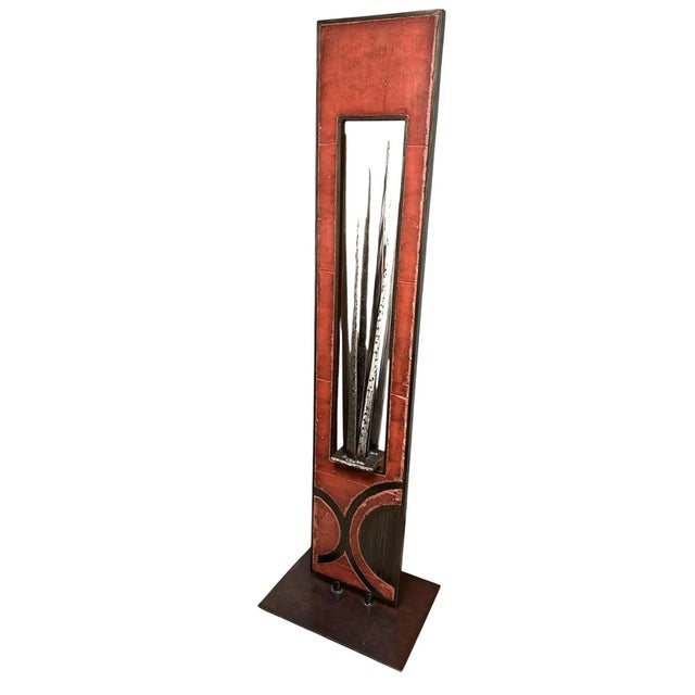 This tall, free standing, indoor/outdoor modern sculpture signed by Carlos Page features abstract mixed hand-forged metals...