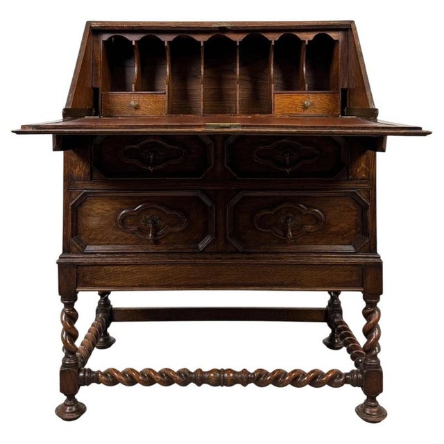 A beautifully crafted early 20th-century English oak bureau, designed in the Jacobean style and combining practical...