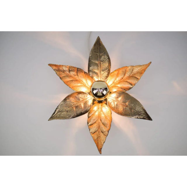 A gold wall sconce or wall light by belgian designer willy daro for lighting manufacturer massive. It has a wonderful...