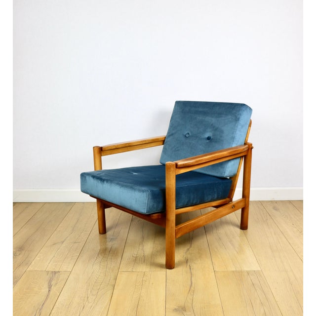 Wooden vintage armchair in brown and sea blue, designed by Z. Bączyk, made of light wood. A 1970s armchair designed by Z....