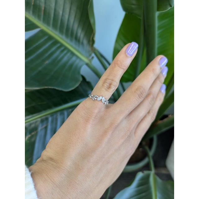 Ten marquise-cut earth-mined diamonds sparkle across this solid 14K white gold band, their tapered points giving it a...