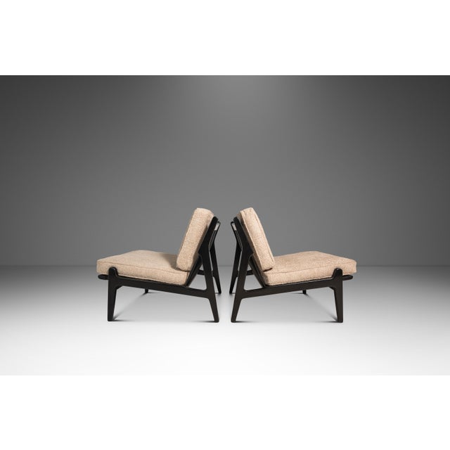 This rare pair of ebonized lounge chairs, attributed to Ib Kofod-Larsen for Selig, beautifully embodies the refined...