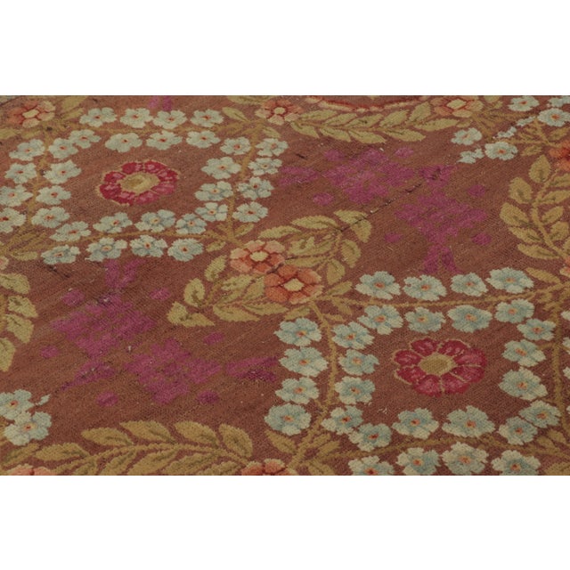 This 4x9 vintage French Art Deco runner, hand-knotted in wool circa 1950–1959, features an allover trellis of floral...