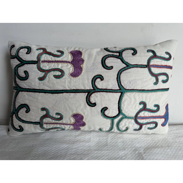 Vintage 1900 Suzani Pillow, 14"x8"—a stunning hand-embroidered piece showcasing intricate patterns and rich, vibrant...