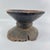 This traditional Ugandan wooden stool is hand-carved from a single block of hardwood and features a shallow concave seat...