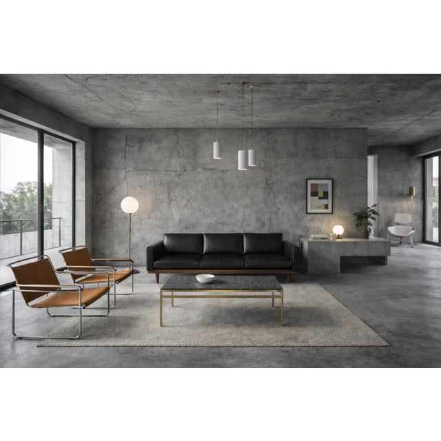 This modernist coffee table was manufactured in Italy during the 1970s. The tabletop, crafted from a refined, dark stone...