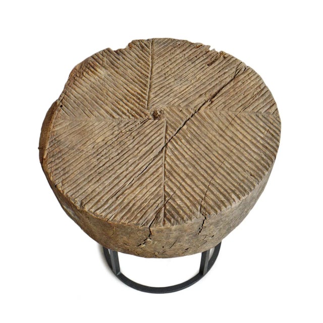 Old wood wheel from India repurposed into a one of a kind side table with modern black iron base. Wonderful original signs...