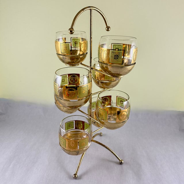 A set of eight Mid-Century roly-poly glasses in the Golden Celeste pattern by Georges Briard, in a chrome gold plated...