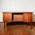 Vintage double-sided teak veneer desk, featuring a central lockable drawer and two three-drawer units (one lockable) on...