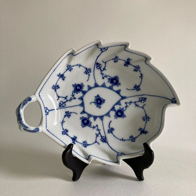 A classic, hand painted blue & white porcelain leaf shaped dish featuring a traditional floral pattern design by Royal...