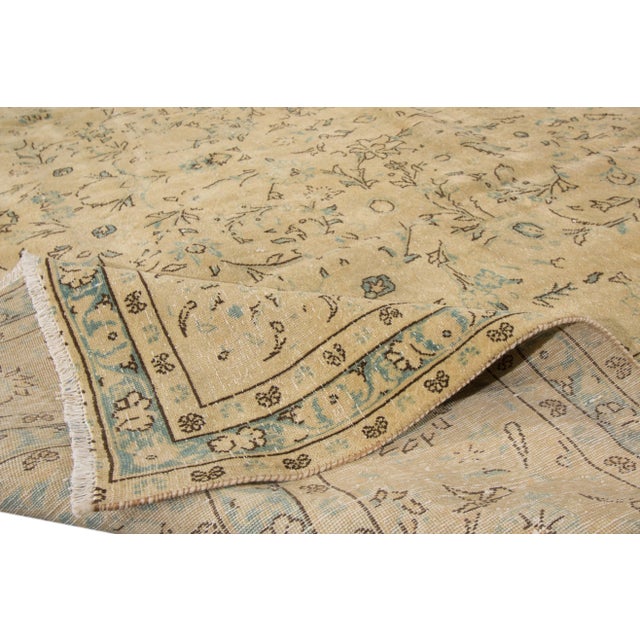 Beautiful Vintage Persian hand-knotted Wool Rug with a Beige field. This rug has tan and green accents in an all-over a...