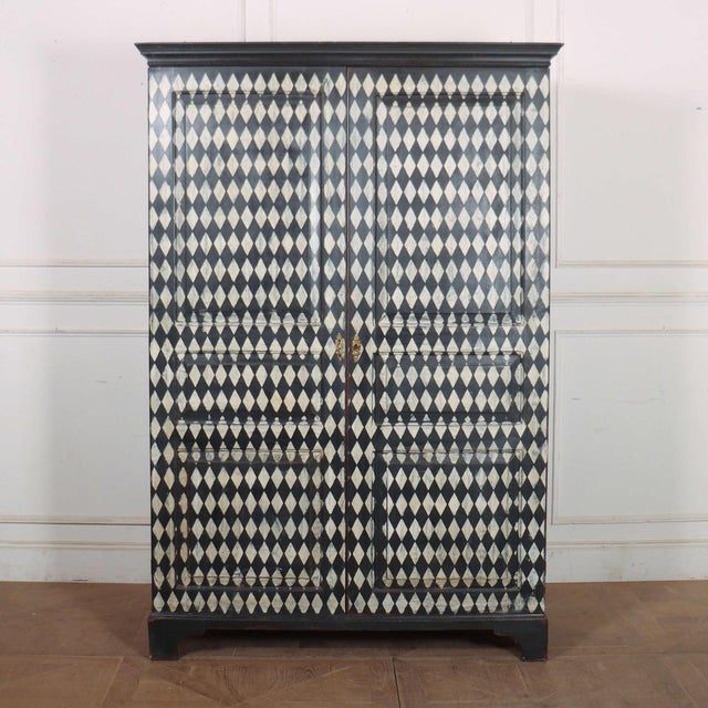 Early 19th C English wardrobe with later harlequin painted decoration. This piece is designed in the style of the selected...