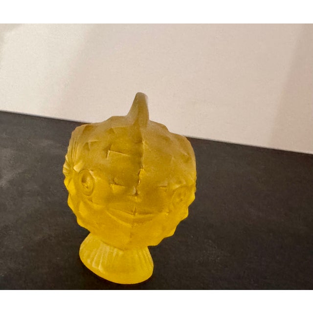 Lalique amber/yellow crystal fish figurine in miniature size, with molded fins and body detail, as shown.