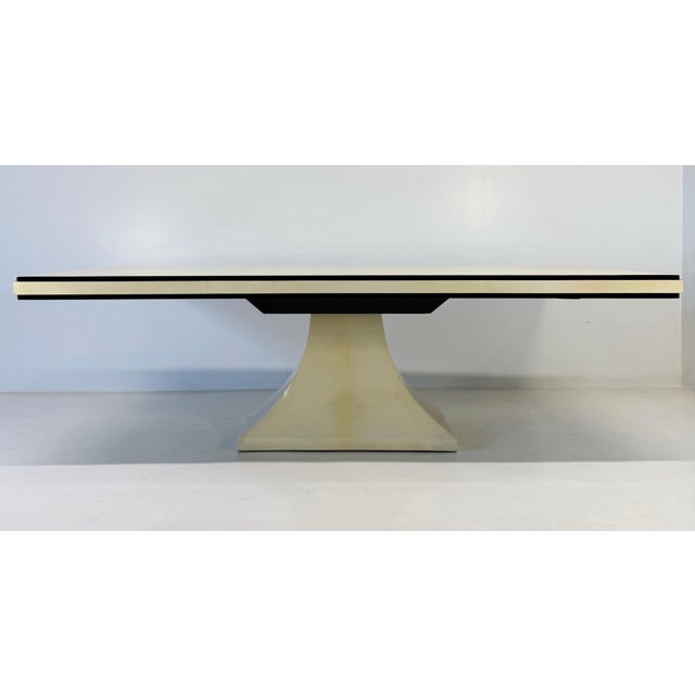 Refined Italian Art Deco table from the 1940s, featuring a sophisticated top entirely upholstered in parchment leather,...