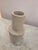 Two tiered stone vase, textured ripple detail and white-stone coloring