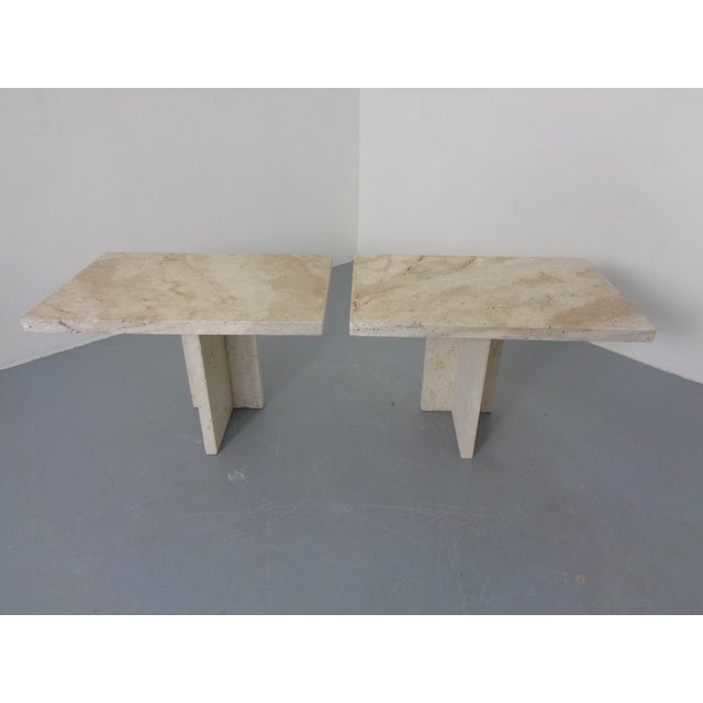 A pair of small, very heavy Italian tables made of solid travertine. Design from the 1970s.