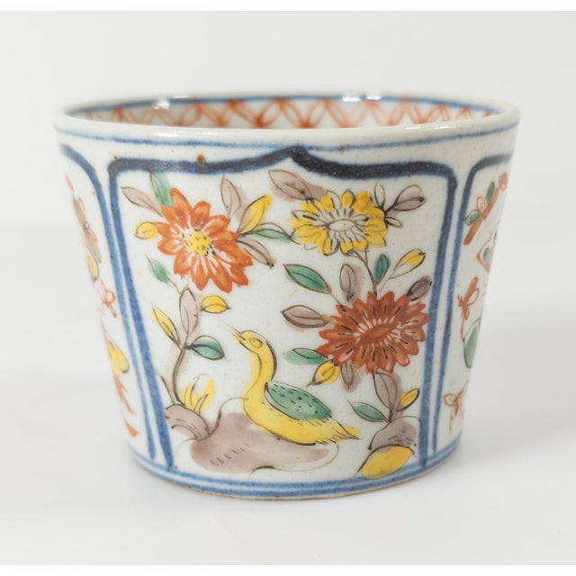We are selling this well decorated early Japanese 18th century Imari cup. This Ming Wucai style cup has butterfly, goose...