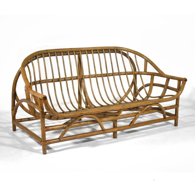 This lovely rattan sofa has a dynamic frame of curved and swooping lines which make it a delight from every angle. The...