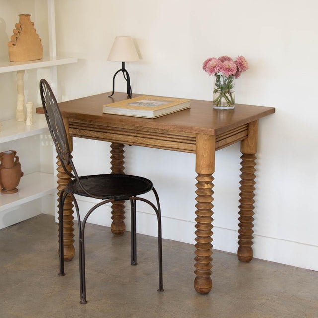 Great wood table by Charles Dudouyt, made in France, 1940's. Rectangular top with four thick carved wood legs and ball...
