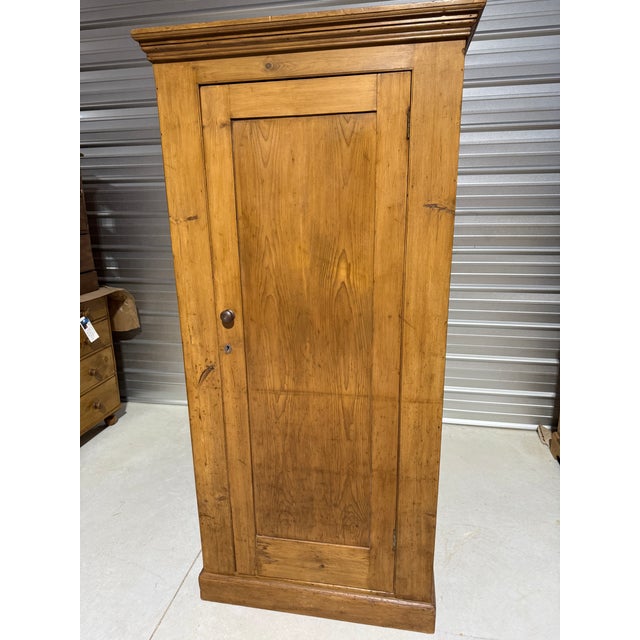 Antique Pine Single Door Cupboard From England This cupboard has three shelves and the key. It was found in northeastern...