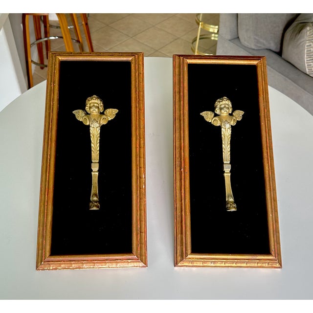 Pair of French late 19th century partial gilt bronze angel or cherub figures fragments mounted in frames with black velvet...